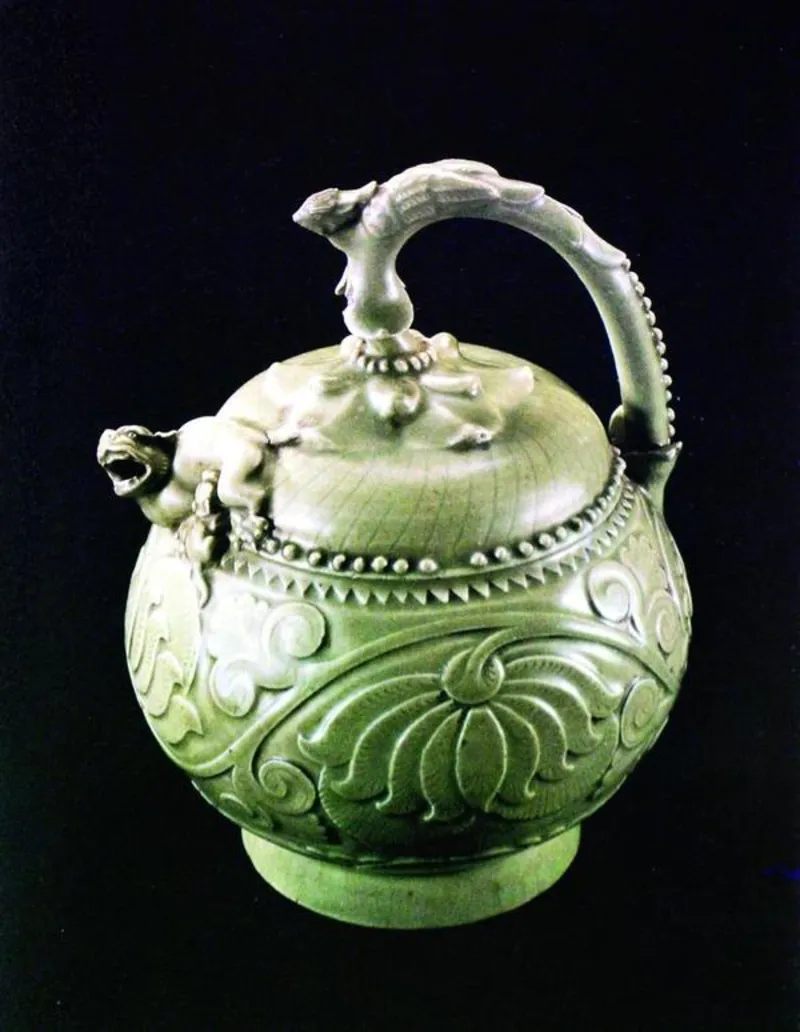 Reference image: the historic Yaozhou celadon reverse-flow ewer — carved floral relief and arching handle — the form lineage behind the Long Origin ewer